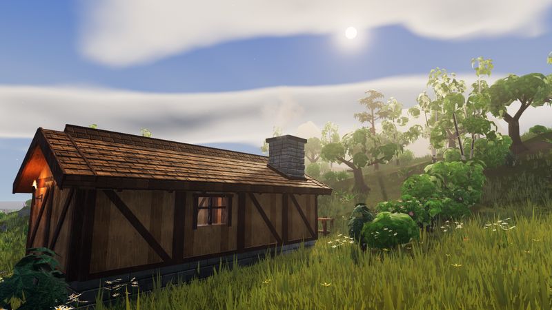 A timber house with a stone chimney on a sunny hillside.