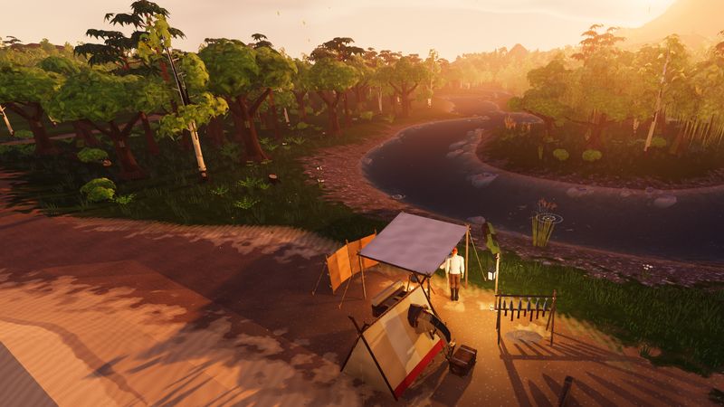 A tent and a lantern by a river at sunset.